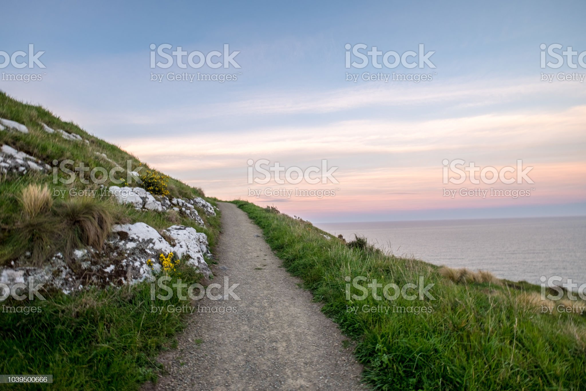 The path is beautiful. It looks as if the road is going nowhere. As the sun is settings, the sky is colourful and vibrant. I can see into the horizon.